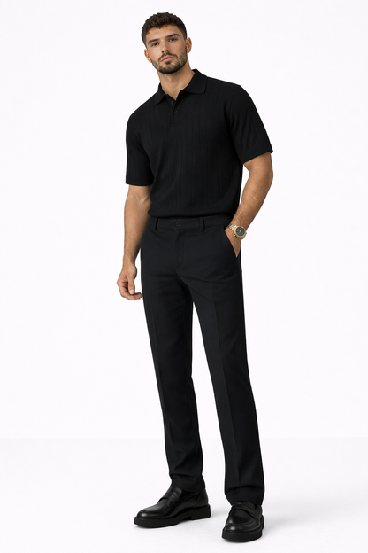 Men’s black tailored dress pants styled with black ribbed polo shirt and black loafers front view