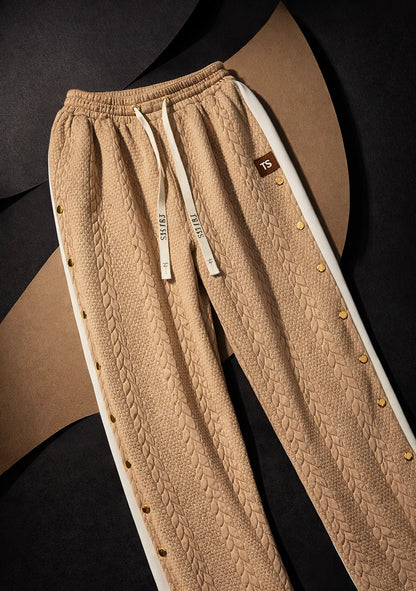 Camel taupe waffle knit pants close-up with textured fabric, drawstring waist, and gold hardware detail